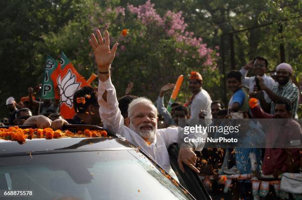Prime Minister of India Narendra Modi waves to crowd after arrives in the eastern Indian state Odisha's capital city Bhubaneswar on 15 April 2017,...