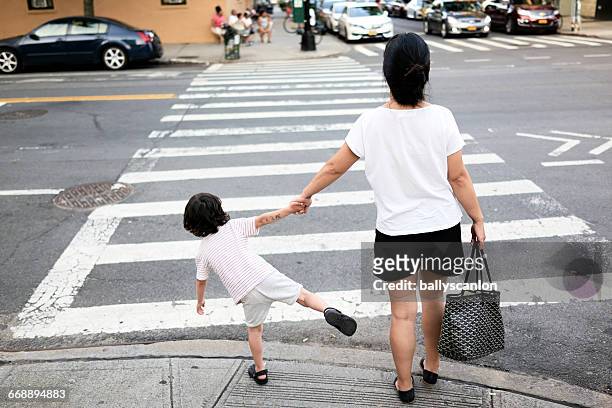 mother and son on street. - pulling fotografías e imágenes de stock