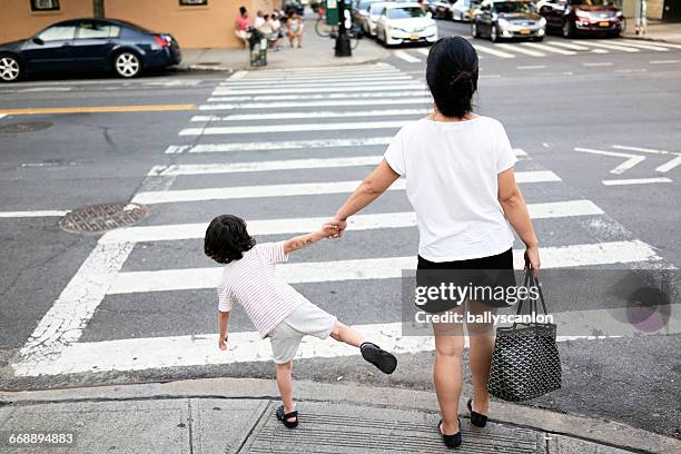 mother and son on street. - arrastar imagens e fotografias de stock