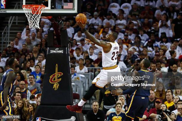 LeBron James of the Cleveland Cavaliers gets to the basket past CJ Miles of the Indiana Pacers during the first half in Game One of the Eastern...