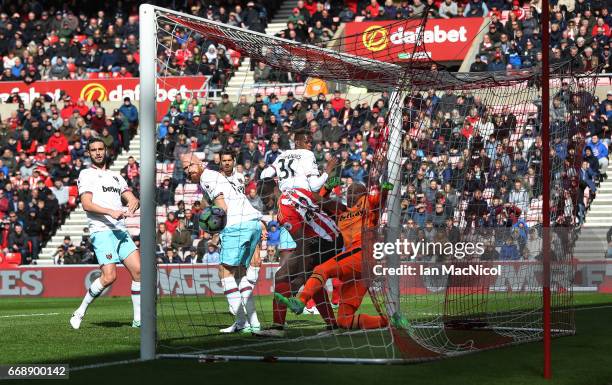 Victor Anichebe of Sunderland challenges Darren Randolph of West Ham United as Wahbi Khazri of Sunderland scores his sides first goal during the...