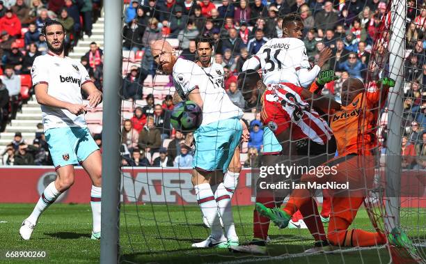 Victor Anichebe of Sunderland challenges Darren Randolph of West Ham United as Wahbi Khazri of Sunderland scores his sides first goal during the...