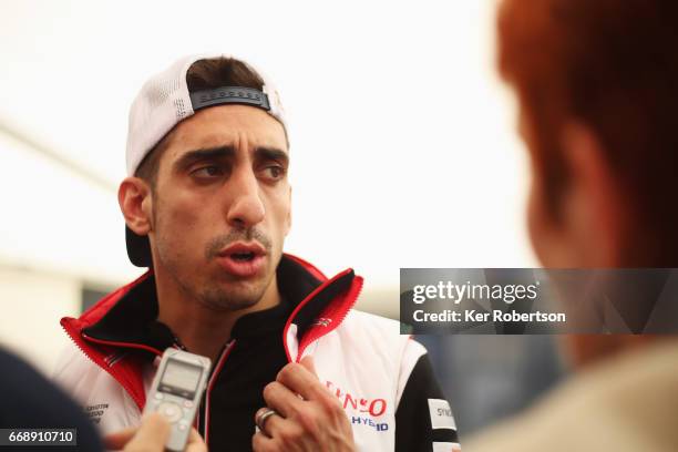 Sebastien Buemi of France and Toyota Gazoo Racing is interviewed by the media following qualifying for the FIA World Endurance Championship at...