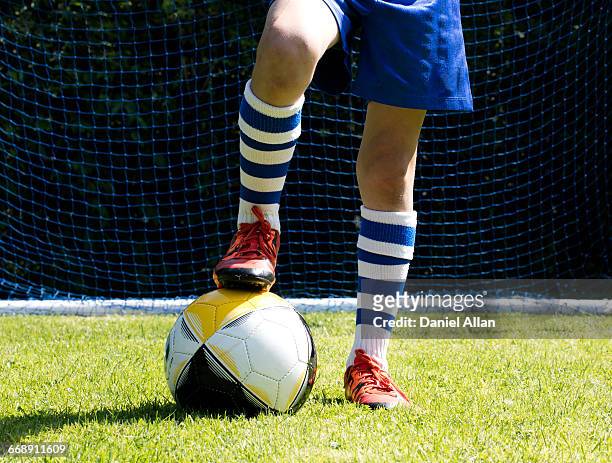 boys football and boots - football boot stock pictures, royalty-free photos & images
