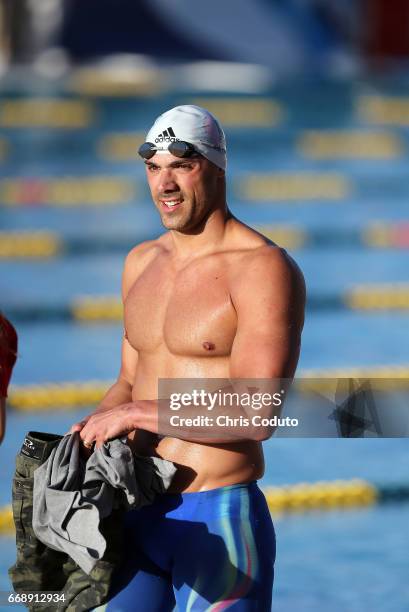 Joao De Lucca walks off the deck after competing in the finals of the men's 200 meter freestyle on day two of the Arena Pro Swim Series - Mesa at...