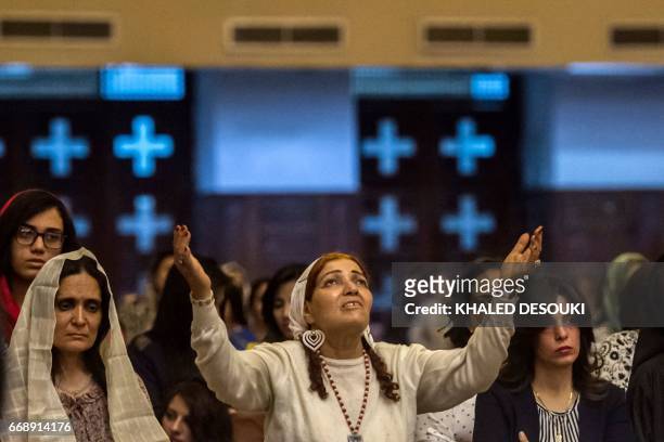 Egyptian women attend an Easter mass led by Egypt's Coptic Christian, Pope Tawadros II at the Saint Mark's Coptic Cathedral, in Cairo's al-Abbassiya...