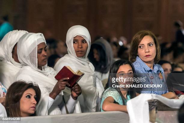 Ethiopian Christian Orthodox women attend an Easter mass led by of Egypt's Coptic Christian, Pope Tawadros II at the Saint Mark's Coptic Cathedral,...