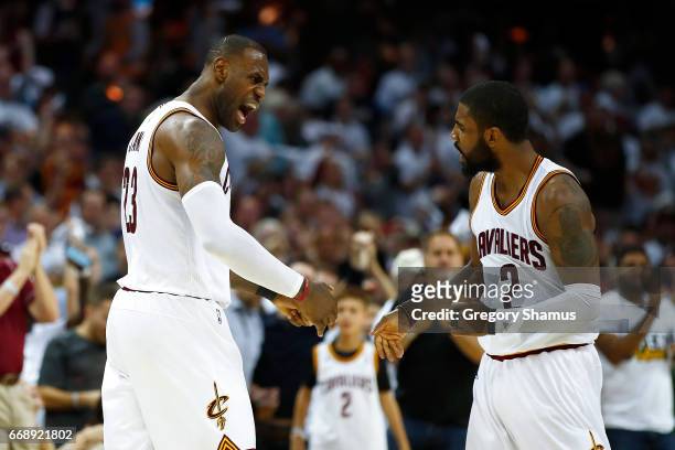 LeBron James of the Cleveland Cavaliers celebrates a second half dunk with Kyrie Irving while playing the Indiana Pacers in Game One of the Eastern...