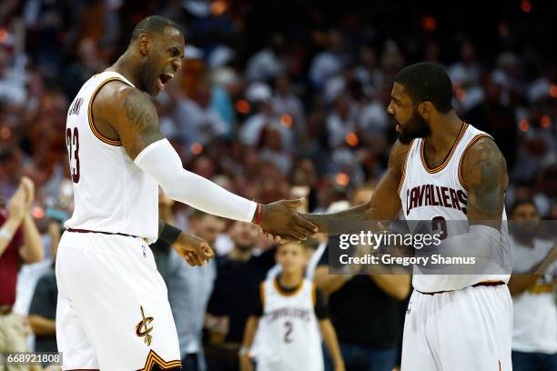 LeBron James of the Cleveland Cavaliers celebrates a second half dunk with Kyrie Irving while playing the Indiana Pacers in Game One of the Eastern...