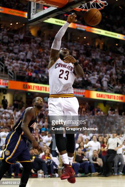 LeBron James of the Cleveland Cavaliers gets in for a dunk next to CJ Miles of the Indiana Pacers during the second half in Game One of the Eastern...