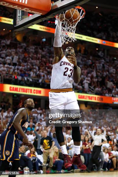 LeBron James of the Cleveland Cavaliers gets in for a dunk next to CJ Miles of the Indiana Pacers during the second half in Game One of the Eastern...