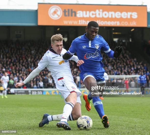 Bolton Wanderers' Josh Vela battles with Oldham Athletic's Temitope Obadeyi during the Sky Bet League One match between Oldham Athletic and Bolton...