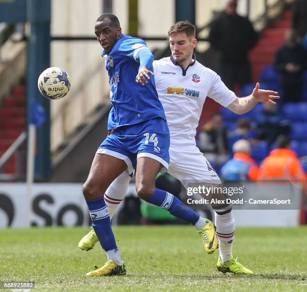 Oldham Athletic's Michael Ngoo holds off the challenge from Bolton Wanderers' Dorian Dervite during the Sky Bet League One match between Oldham...