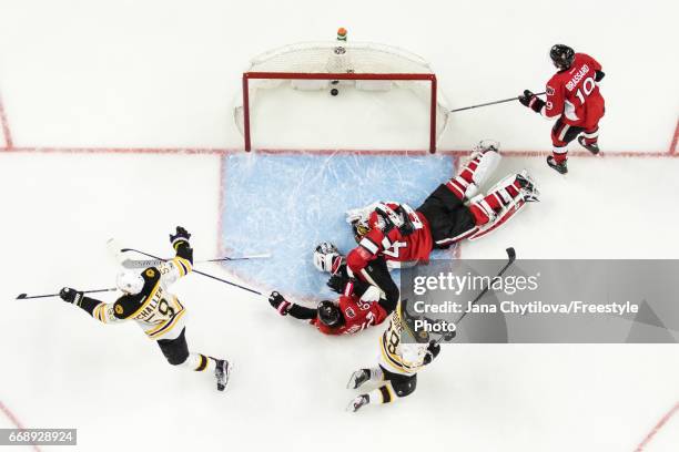 Tim Schaller of the Boston Bruins in Game celebrates his second period shorthanded goal as Erik Karlsson, Craig Anderson and Derick Brassard of the...