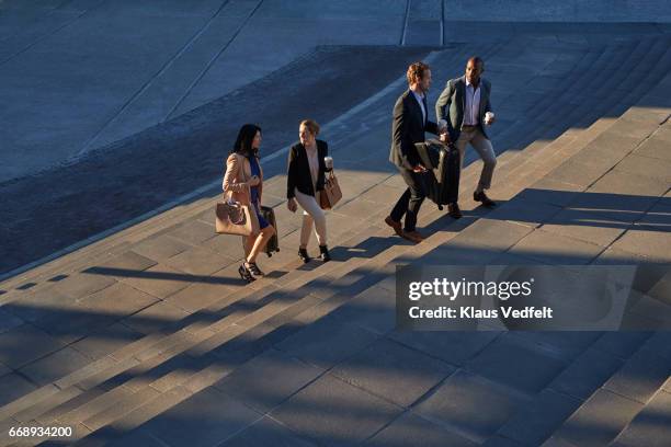 businesspeople walking on staircase outside - white collar worker dawn light stock pictures, royalty-free photos & images
