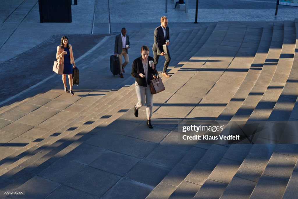 Businesspeople walking on staircase outside