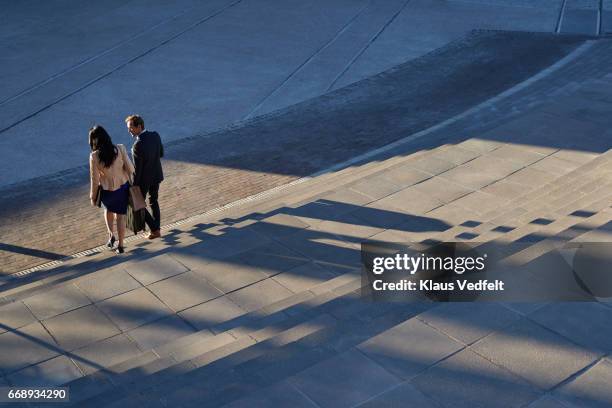 businesspeople walking on staircase outside - anzugträger stock-fotos und bilder