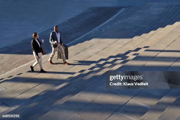 businesspeople walking on staircase outside - business stairs fotografías e imágenes de stock