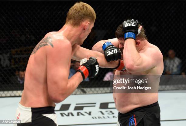 Alexander Volkov of Russia punches Roy Nelson in their heavyweight fight during the UFC Fight Night event at Sprint Center on April 15, 2017 in...