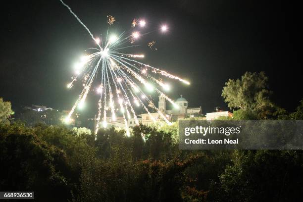 Supporters of the Panaghia Erithiani Church watch rockets burst over the Aghios Marko Church during the annual Rocket War, known locally as the...