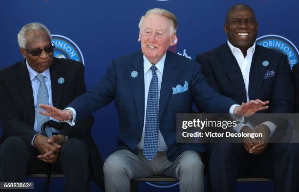 Former Los Angeles Dodgers play by play announcer Vin Scully gestures onstage as former MLB player Frank Robinson, left, and Los Angeles Dodgers...