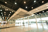 Public event exhibition hall, blurred bokeh defocused background, business trade show or modern interior architecture concept