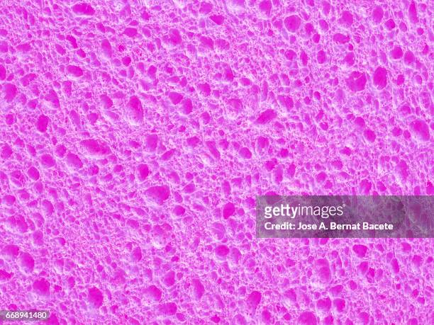 full frame of coarse and wavy textures of colored foam, pink background - con textura stockfoto's en -beelden