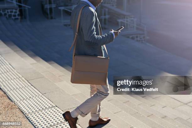 businessman walking on staircase with bags - a buisness man with a brifecase stock-fotos und bilder