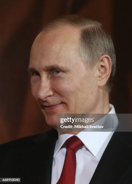 Russian President Vladimir Putin smiles during the Easter Service in the Christ The Saviour Cathedral in Moscow, Russia, early April 2017. Eastern...