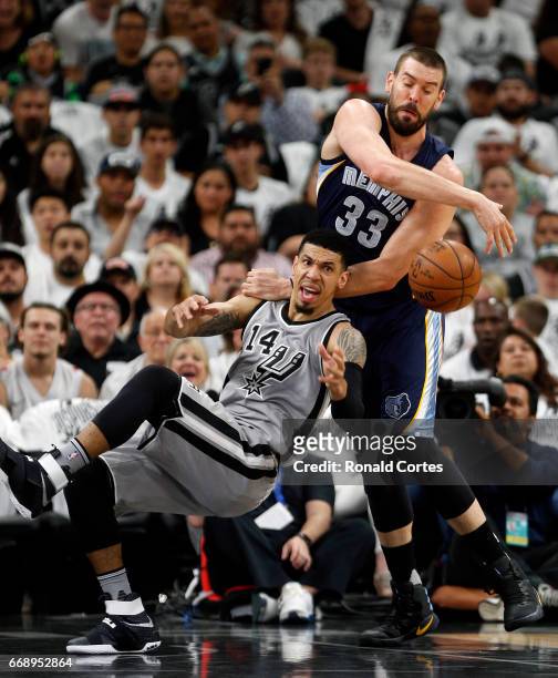 After grabbing a rebound Danny Green of the San Antonio Spurs is fouled by Marc Gasol of the Memphis Grizzlies in Game One of the Western Conference...