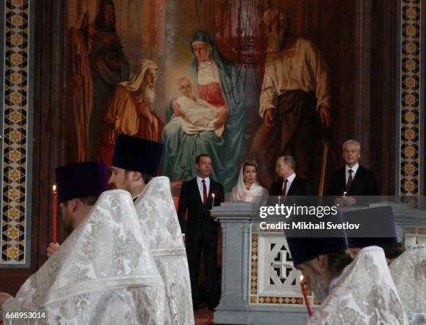 Russian President Vladimir Putin , Prime Minister Dmitry Medvedev , his wife Svetlana Medvedeva and Moscow's Mayor Sergei Sobyanin attend the Easter...