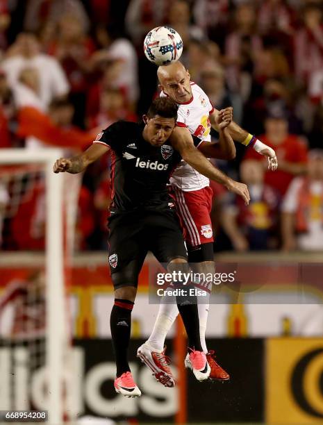 Aurelien Collin of New York Red Bulls and Jose Guillermo Ortiz of D.C. United fight for the ball in the first half at Red Bull Arena on April 15,...