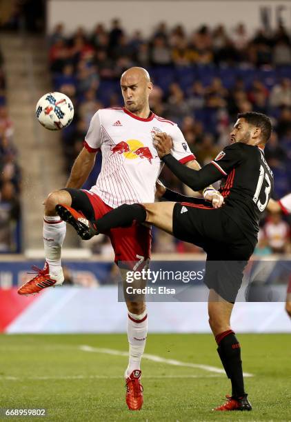 Aurelien Collin of New York Red Bulls and Lamar Neagle of D.C. United fight for the ball in the second half at Red Bull Arena on April 15, 2017 in...