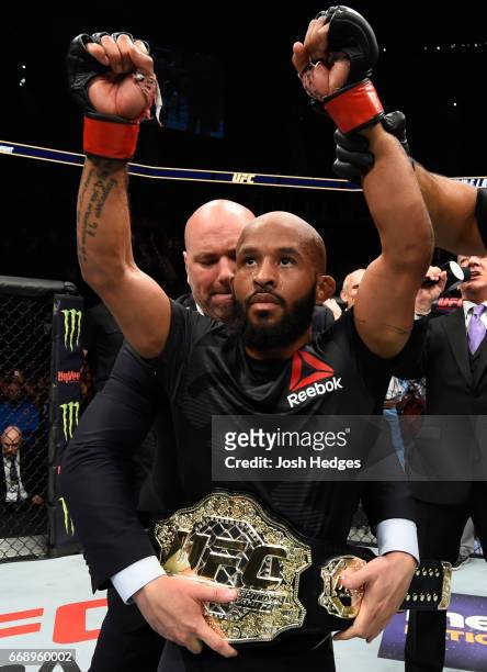 Demetrious Johnson celebrates his submission victory over Wilson Reis of Brazil in their UFC flyweight fight during the UFC Fight Night event at...