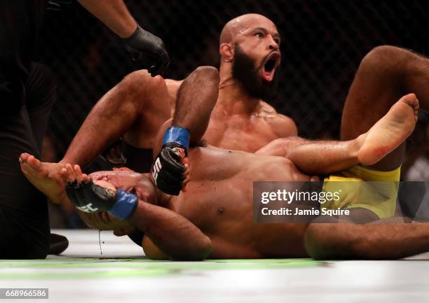 Demetrious Johnson celebrates as he defeats Wilson Reis to win their Flyweight Championship bout on UFC Fight Night at the Sprint Center on April 15,...