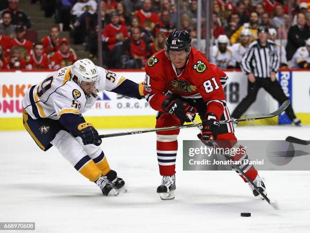 Marian Hossa of the Chicago Blackhawks moves to shoot under pressure from Roman Josi of the Nashville Predators in Game Two of the Western Conference...