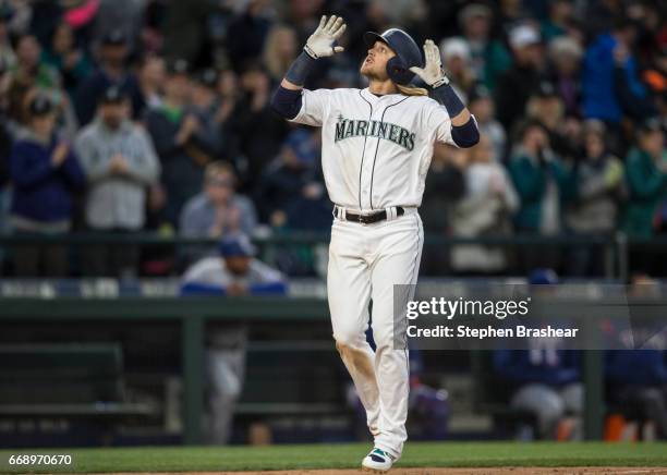 Taylor Motter of the Seattle Mariners celebrates hitting a three-run home run off of relief pitcher Mike Hauschild of the Texas Rangers scoring Kyle...