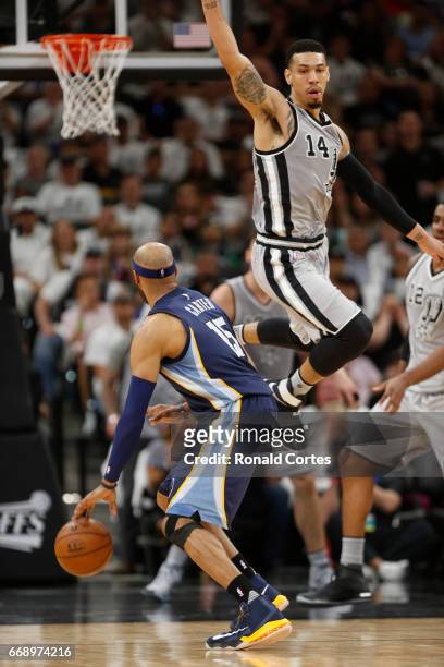 Danny Green of the San Antonio Spurs flies by Vince Carter of the Memphis Grizzlies in Game One of the Western Conference Quarterfinals during the...