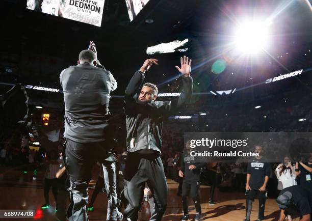 Patty Mills of the San Antonio Spurs greets Dewayne Dedmon of the San Antonio Spurs during player introduction before game against the Memphis...