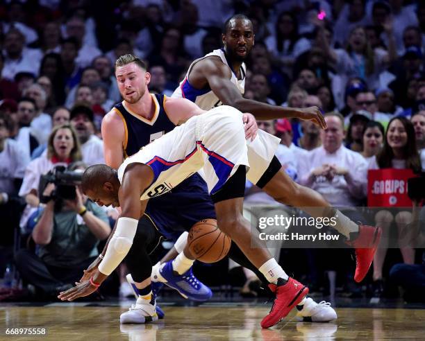 Gordon Hayward of the Utah Jazz collides with Chris Paul of the LA Clippers as he loses the ball as Luc Mbah a Moute looks on during the first half...