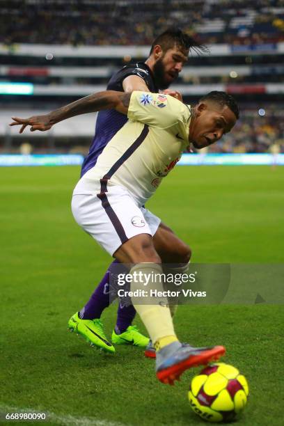 Luis Noriega of Queretaro struggles for the ball with Michael Arroyo of America during the 14th round match between America and Queretaro as part of...