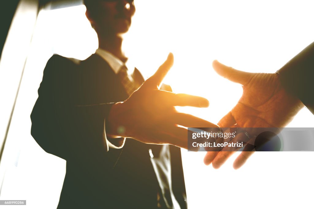 Japanese business handshake inside the office, Japan.