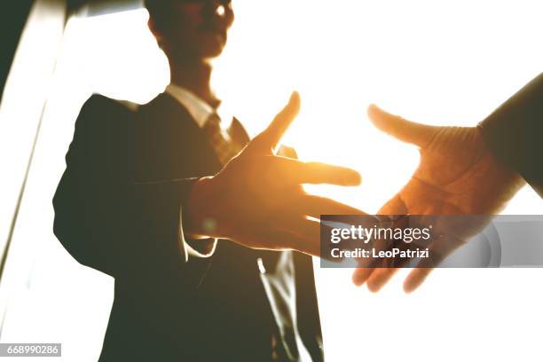 japanese business handshake inside the office, japan. - handshake closeup stock pictures, royalty-free photos & images