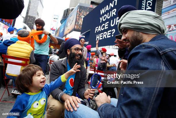 Sikhs of New York arranged for Turban Day in Times Square. Volunteers were on hand to help tie traditional Sikh turbans for all comers, some...