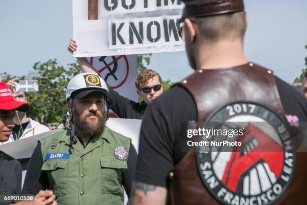 Trump supporter and protester argue during a free speech rally at Martin Luther King Jr. Civic Center Park in Berkeley, California, United States of...