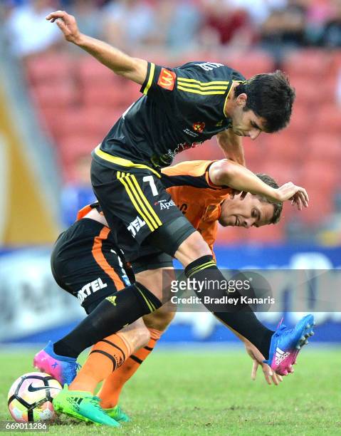 Thomas Kristensen of the Roar and Guilherme Finkler of the Phoenix compete for the ball during the round 27 A-League match between the Brisbane Roar...