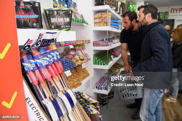 Men browse some of the fireworks and rockets available on the day before the annual Rocket War, known locally as the "Rouketopolemos", on April 14,...