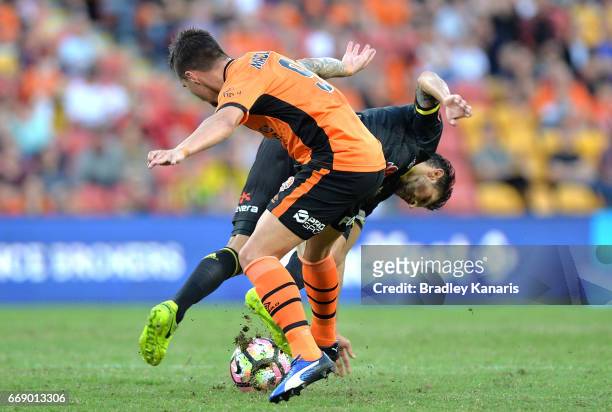 Vince Lia of the Phoenix is tackled by Jamie Maclaren of the Roar during the round 27 A-League match between the Brisbane Roar and the Wellington...