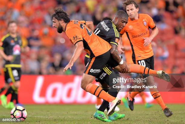Rolieny Bonevacia of the Phoenix is penalised for this challenge on Thomas Broich of the Roar during the round 27 A-League match between the Brisbane...