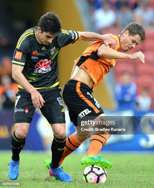 Thomas Kristensen of the Roar and Guilherme Finkler of the Phoenix compete for the ball during the round 27 A-League match between the Brisbane Roar...